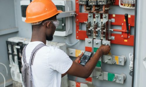 electrician-checking-voltage-in-switchgear-at-solar-station.jpg