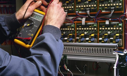 electrician testing industrial machine